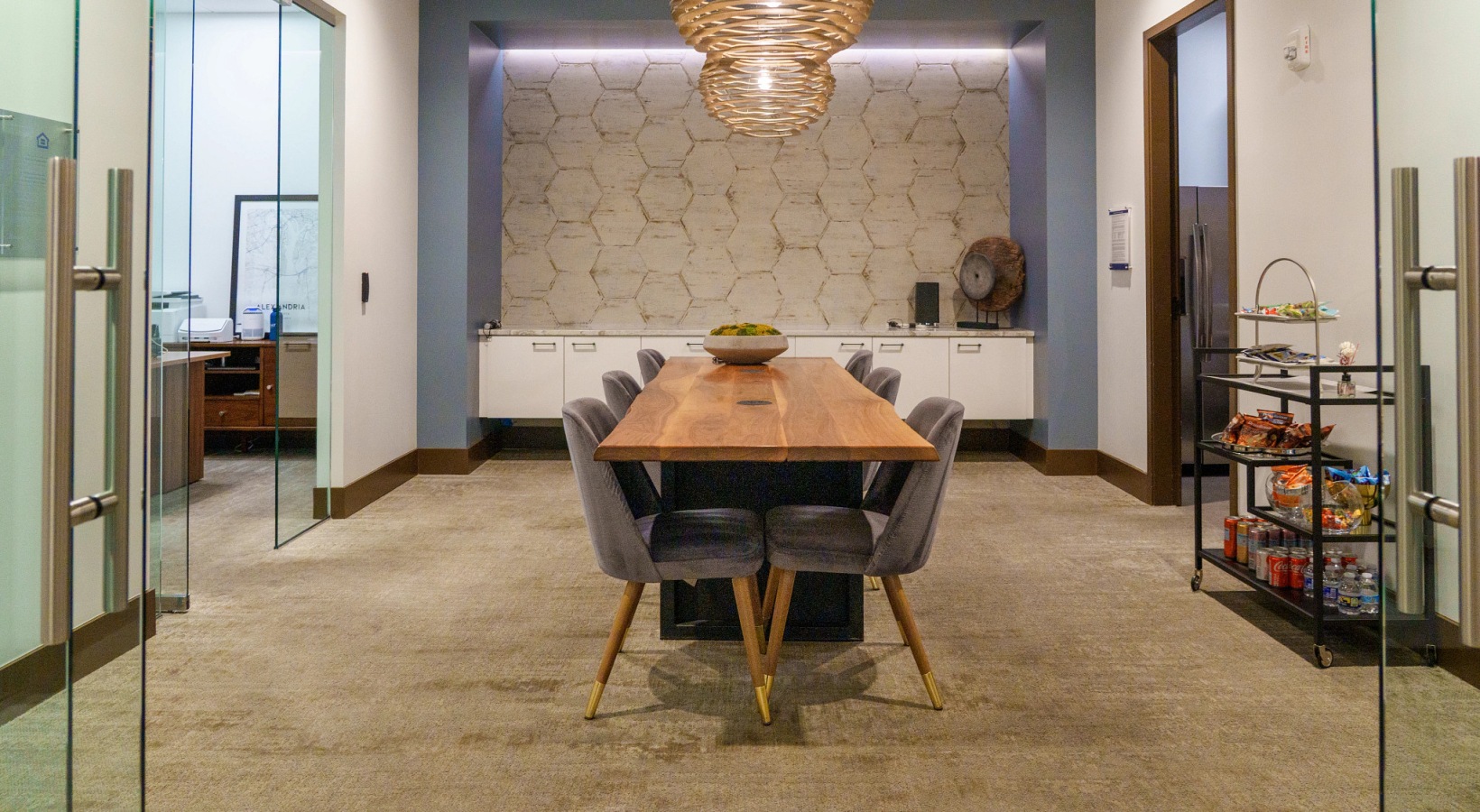 Modern spaces everywhere you look a clubhouse room with a chandelier and a table