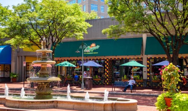 A beautiful community at the heart of all your passions a fountain in front of a building