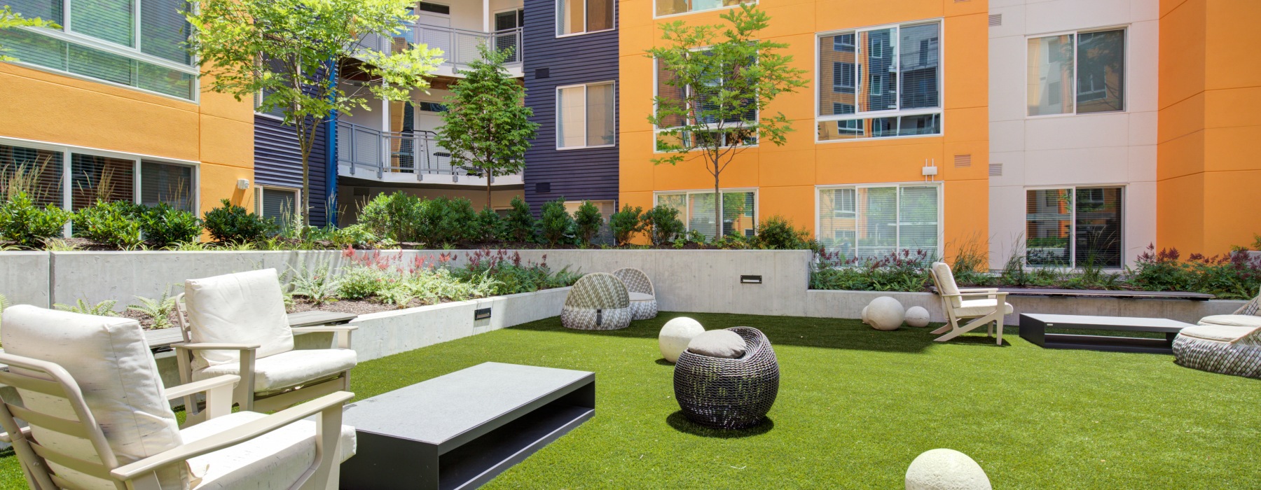 courtyard with greenspace and lounge chairs