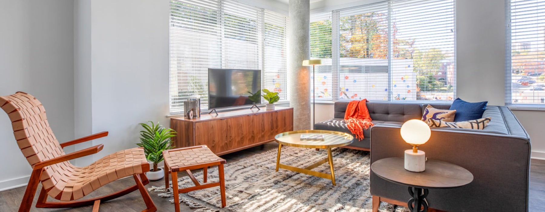 a living room with a tv and chairs
