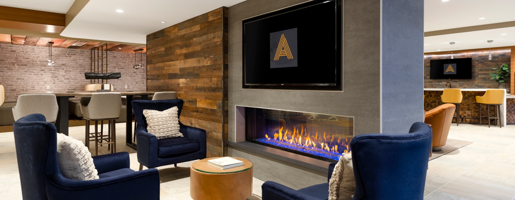 a lounge with chairs and fireplace