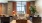 a clubhouse room with a large window, couches and a table