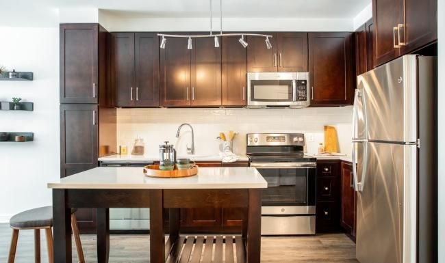 Beautiful kitchens with designer finishes a kitchen with dark wood cabinets
