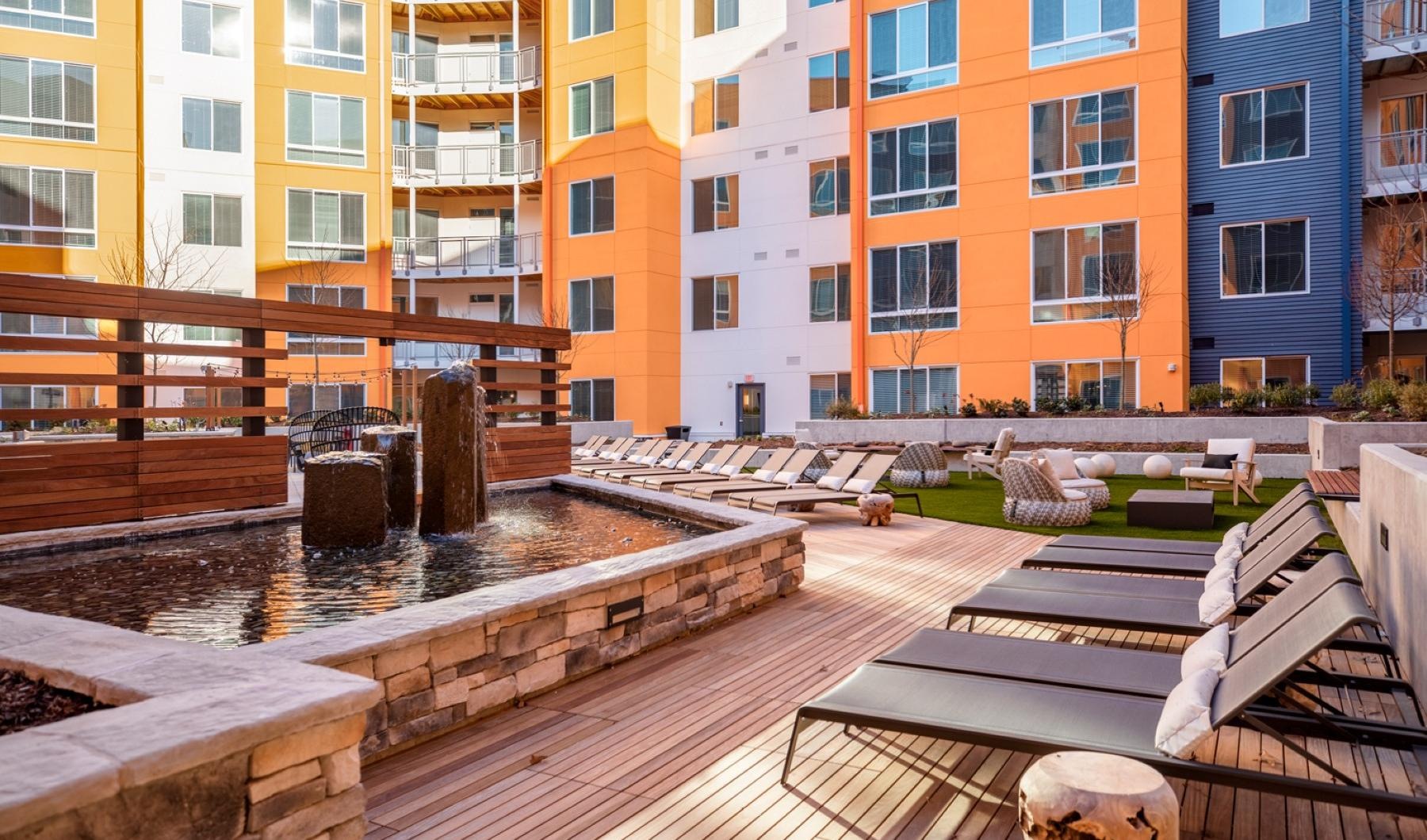 Array of state-of-the-art amenities a courtyard with a fountain and buildings around it