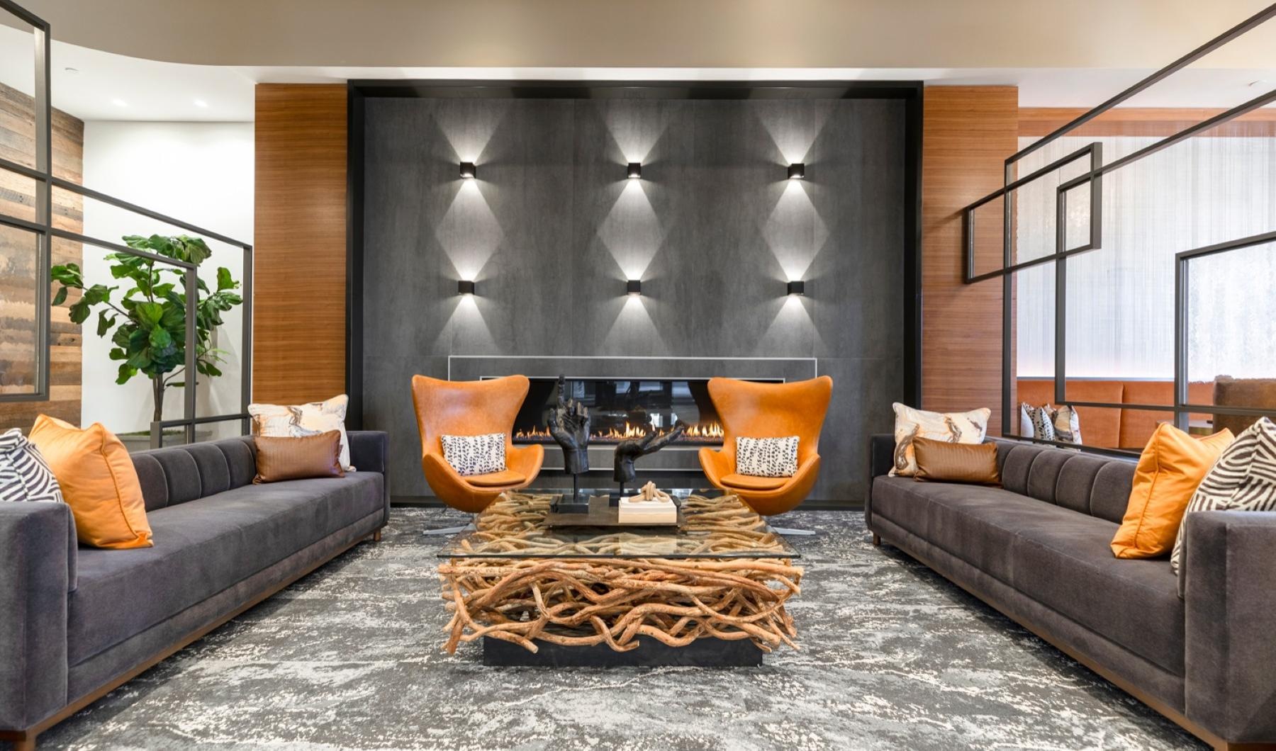 Cutting-edge amenities at your fingertips a clubhouse room with couches and a table