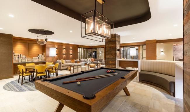 State-of-the-art amenities a pool table in a clubhouse room