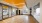a gym with a wood floor and mirrors